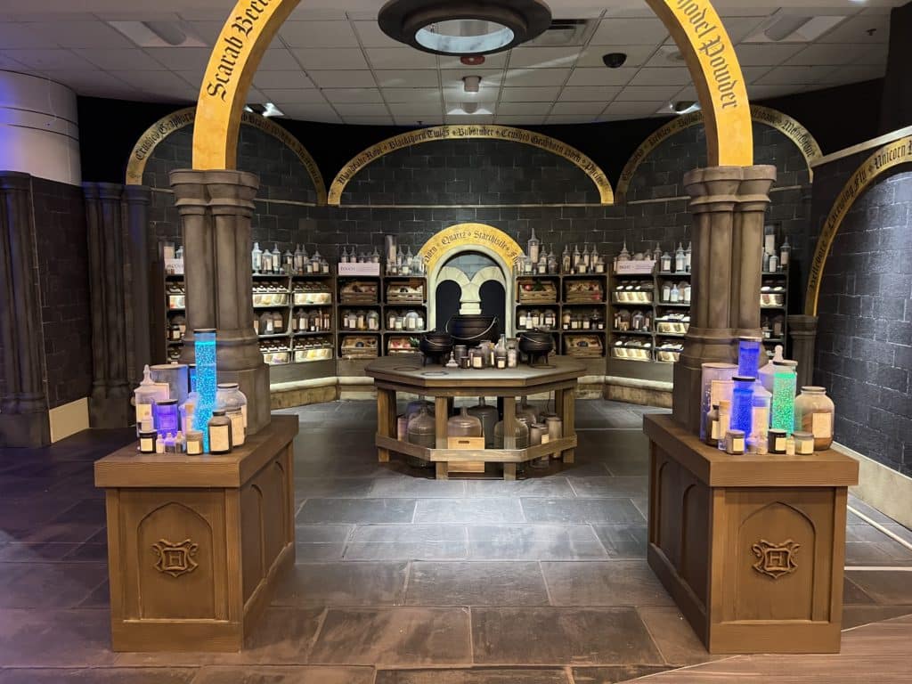 potions room with light up bottles at and large arch at Harry Potter™: Magic at Play 