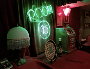 Decor at Room 13 shows a neon sign, vintage lamps