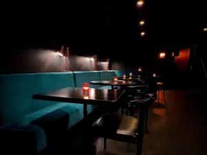 Interior of Nightshade shows booths, tables and a dimly lit atmosphere