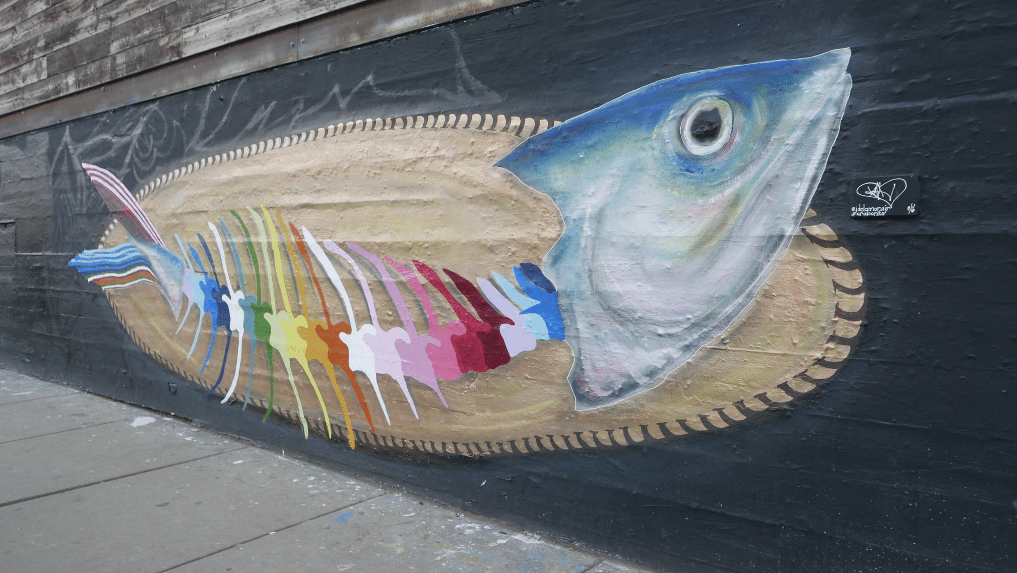 a large fish with colorful bones painted on as a mural on the entrance of the violet hour