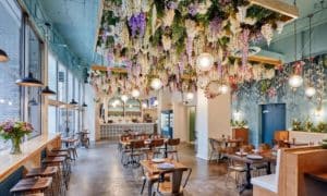 Photo of a Chicago brunch spot open for customers with tables, plates and floral decorations in view.