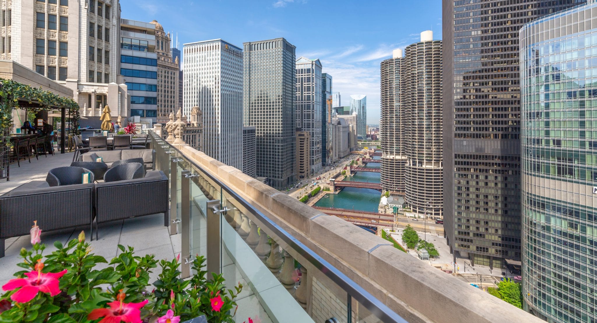 Photo of flowers and seats on a rooftop terrace overlooking the Chicago River