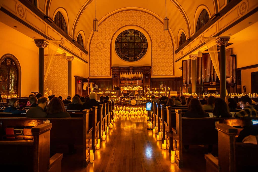 The nave of Wicker Park Lutheran Church lit up by hundreds of candles