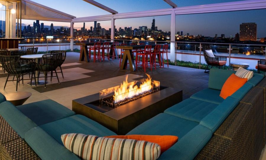 Photo of rooftop with a firepit and the Chicago skyline in the background