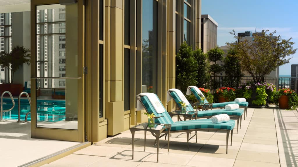 The Pool sundeck with three sun bathing chairs at Peninsula Spa Pool