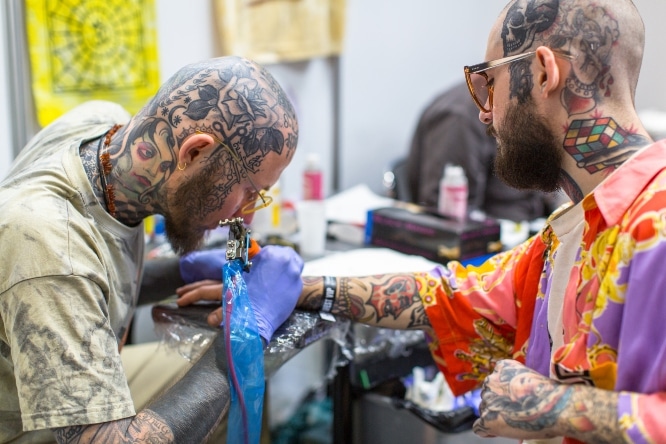 Tattooist working on a customer