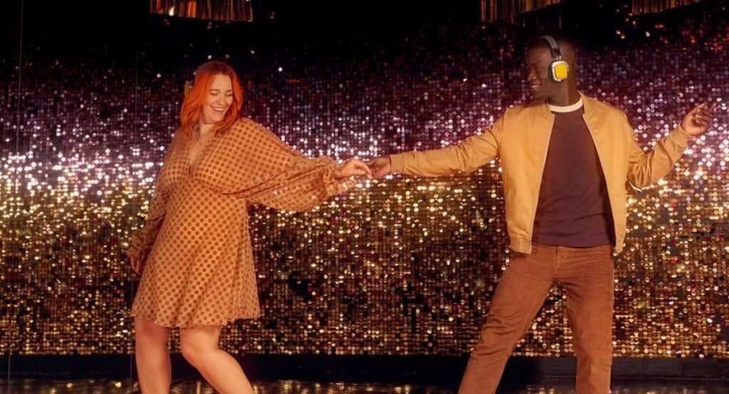 Two people dancing in a sparkly room