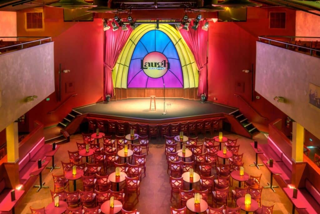 Interior of the Laugh Factory shows a colorful stage and seating