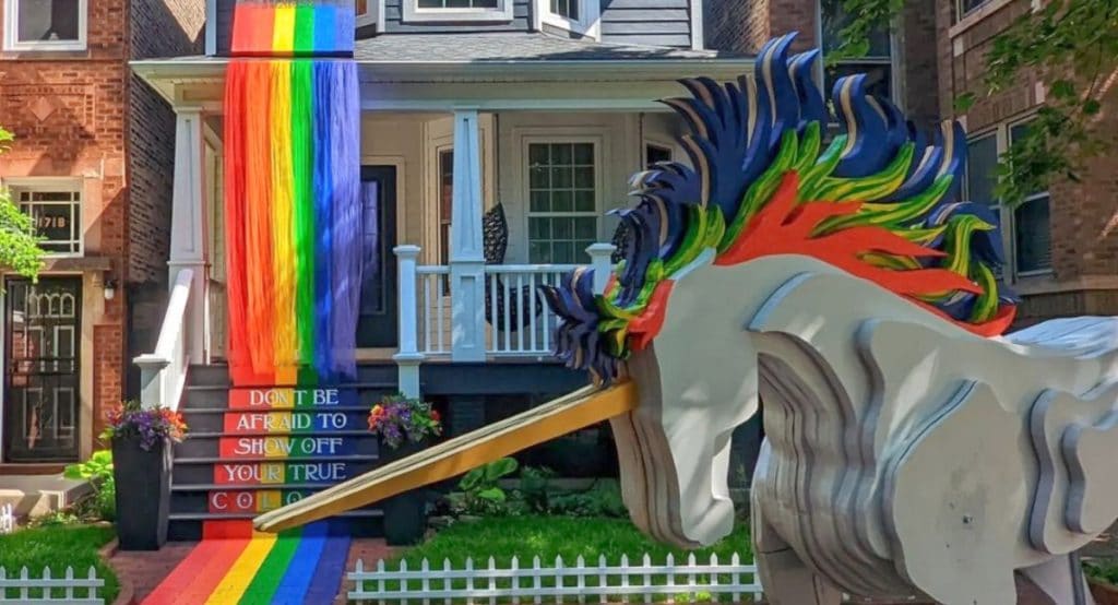 Pride House display shows rainbow mural and hand crafted unicorn