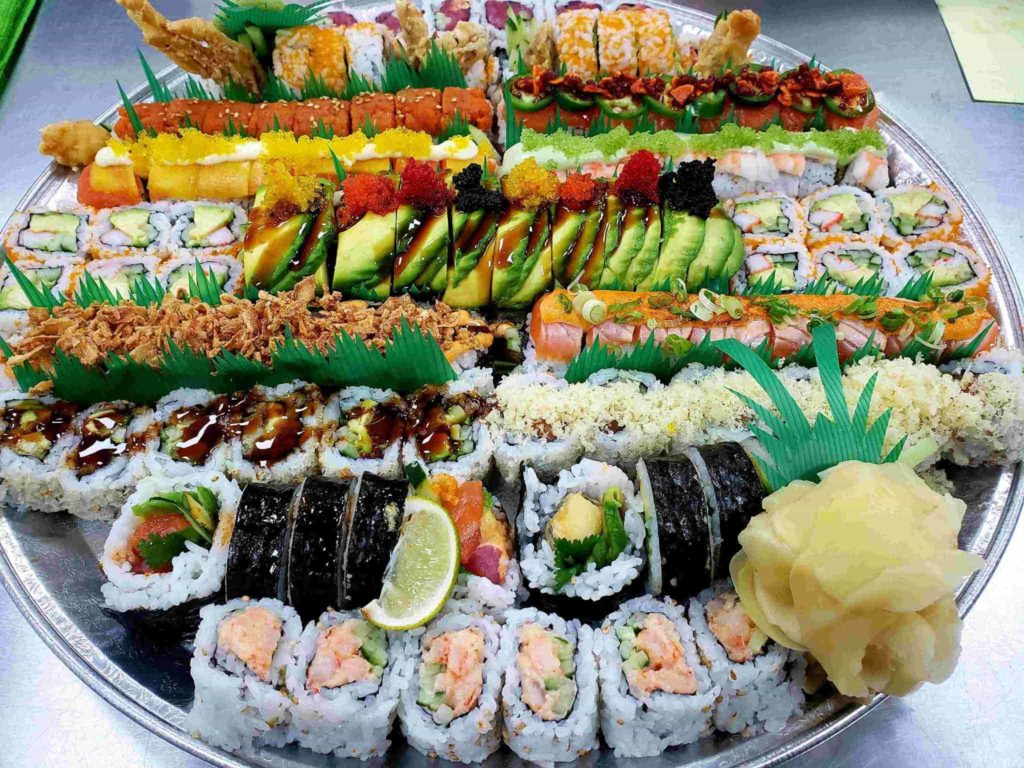 sushi tray from lawrence fish market featuring a salmon roll, tuna roll, california roll, and shrimp roll