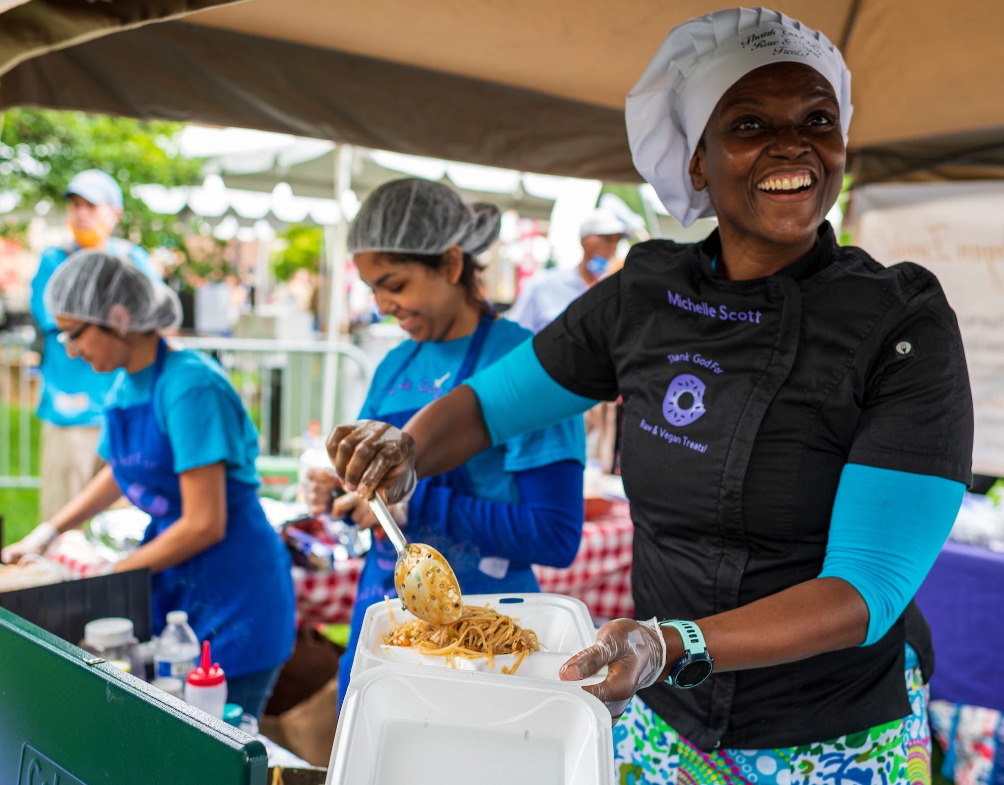 Still image of a person serving food at the festival