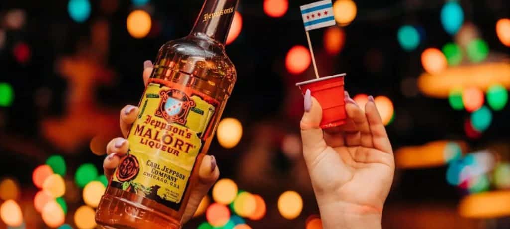 Malört bottle with a shot glass featuring a tiny chicago flag
