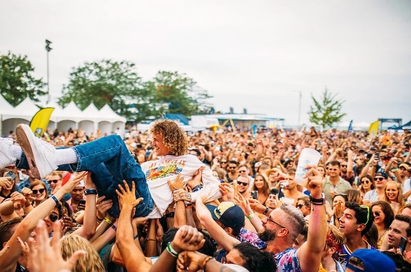 Crowd carrying musician as he crowd surfs