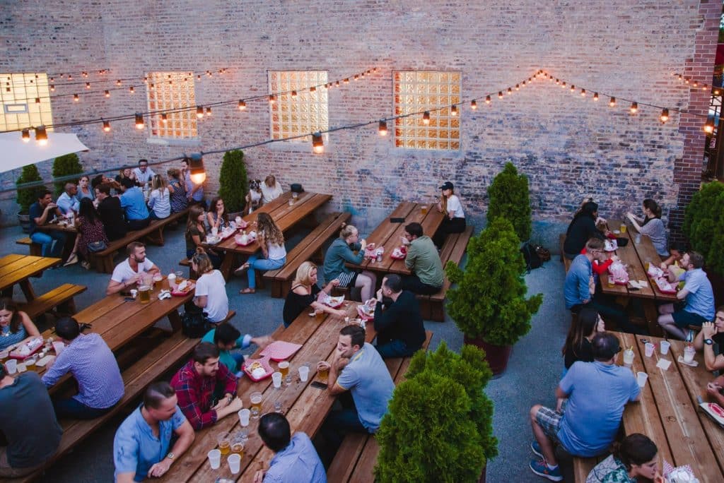 Outdoor patio at new restaurant seen populated with customers