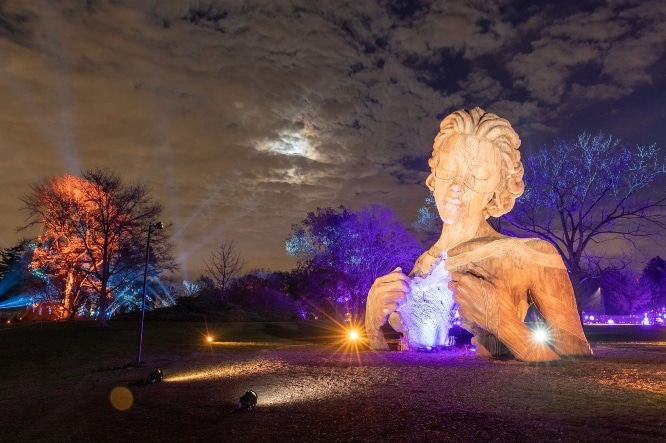 Human + Nature sculpture seen with lights