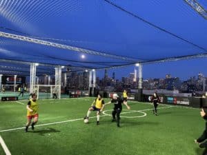 Image showing people playing soccer in a coed league match at Skyline Pitch in Chicago