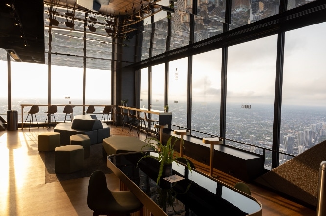 CloudBar during the day with tables and chairs and the large transparent glass windows 