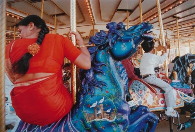 Photo taken by Gauri’ Gills shows women's back on a merry go round