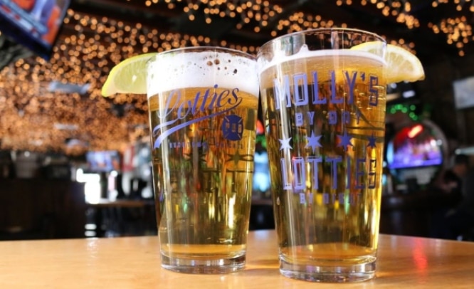 Two beers seen in monogramed glasses
