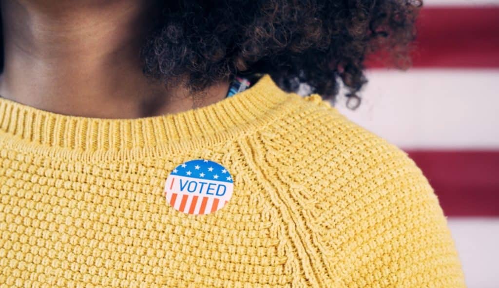 Voting sticker on a yellow sweater