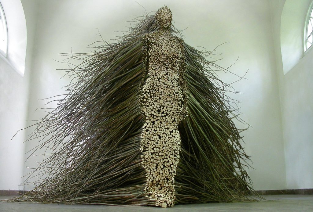 Photo of a sculpture by Olga Ziemska showing a woman made out of branches and wood.