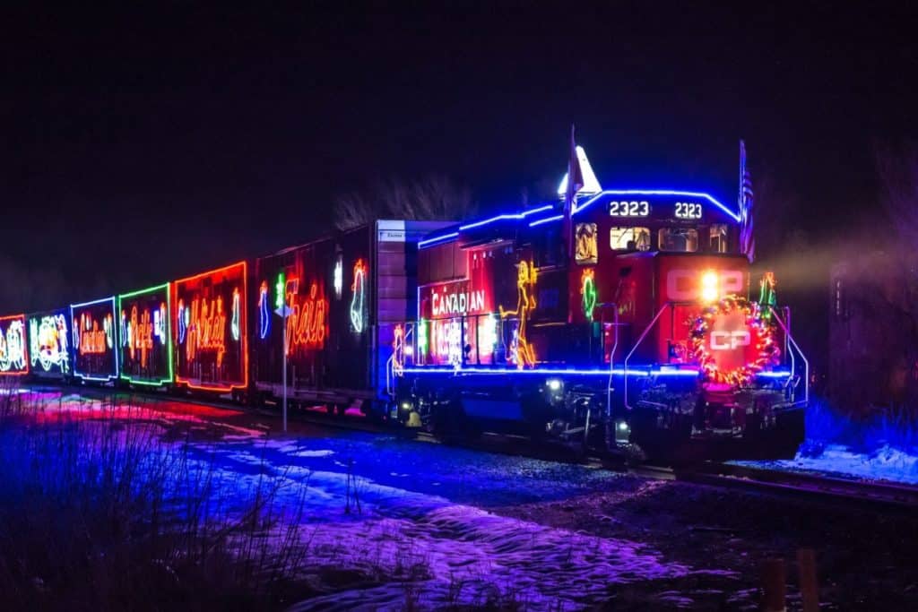 CP Holiday Train lit up on the rails