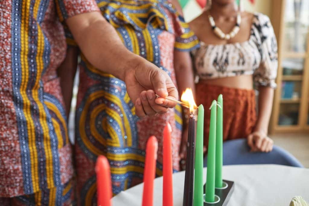 A family lighting Kwanzaa candles