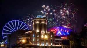 Fireworks pictured against the Navy Pier ferris wheel and buildings