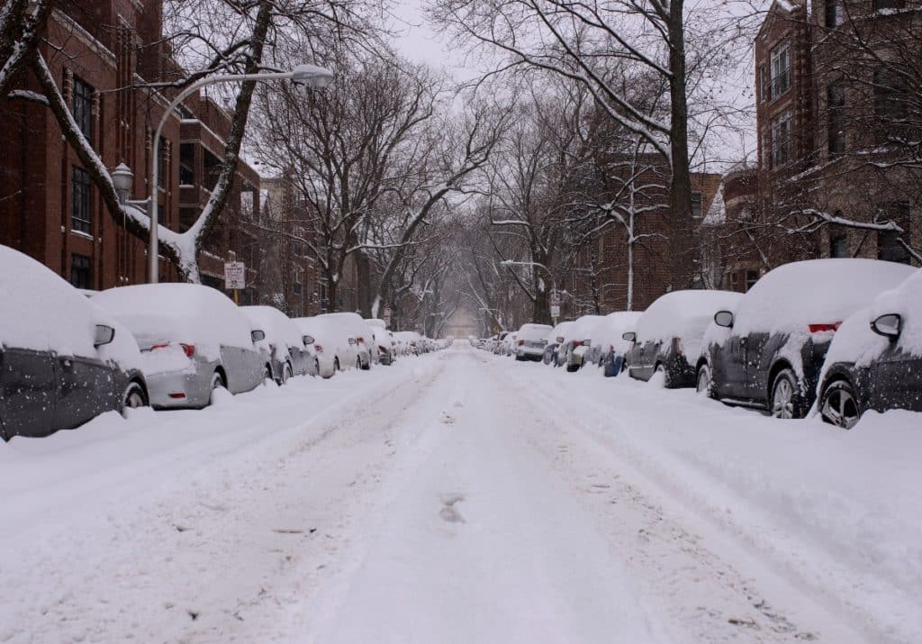 Snow covered cars and street