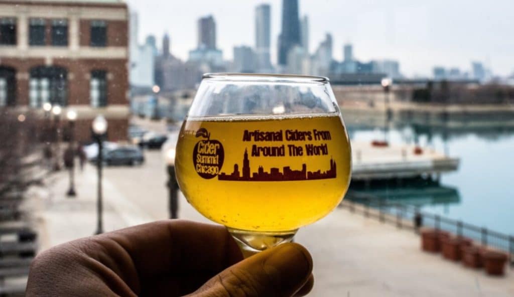 2 oz cider glass seen against the Chicago skyline