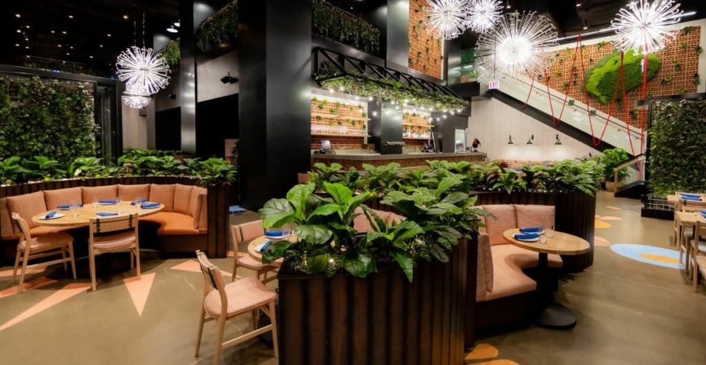 Interior of main dining area featured greenery and wooden accents