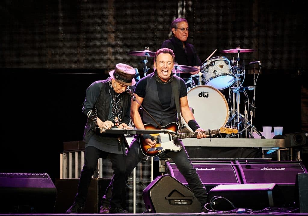 Bruce Springsteen and the E Street Band performing on stage