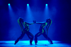 Two women dressed as aliens dance
