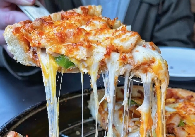 Slice of stuffed pizza being served