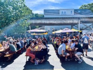 Image showing people enjoying craft beer in the sun at Dovetail Brewery's beer garden in Chicago