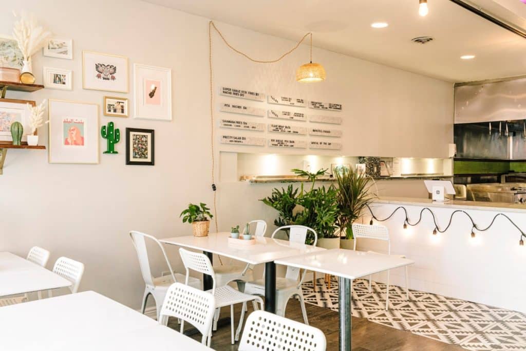 Interior of Evette's Lakeview shows white walls, tables and overhead lighting