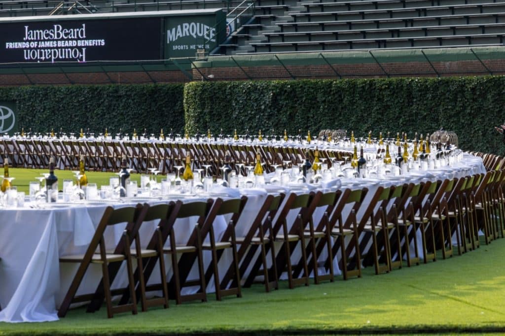 James Beard dinner series shows a long line of tables on Wrigley Field.