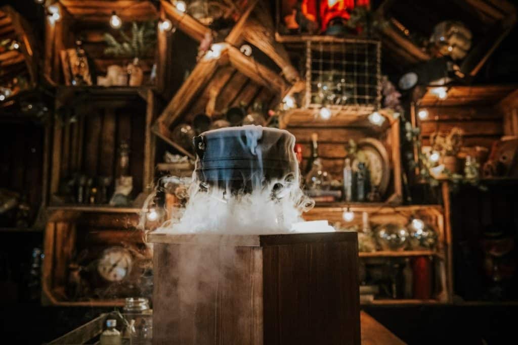 A mixology class setup at The Cauldron featuring potions, wands, and magic