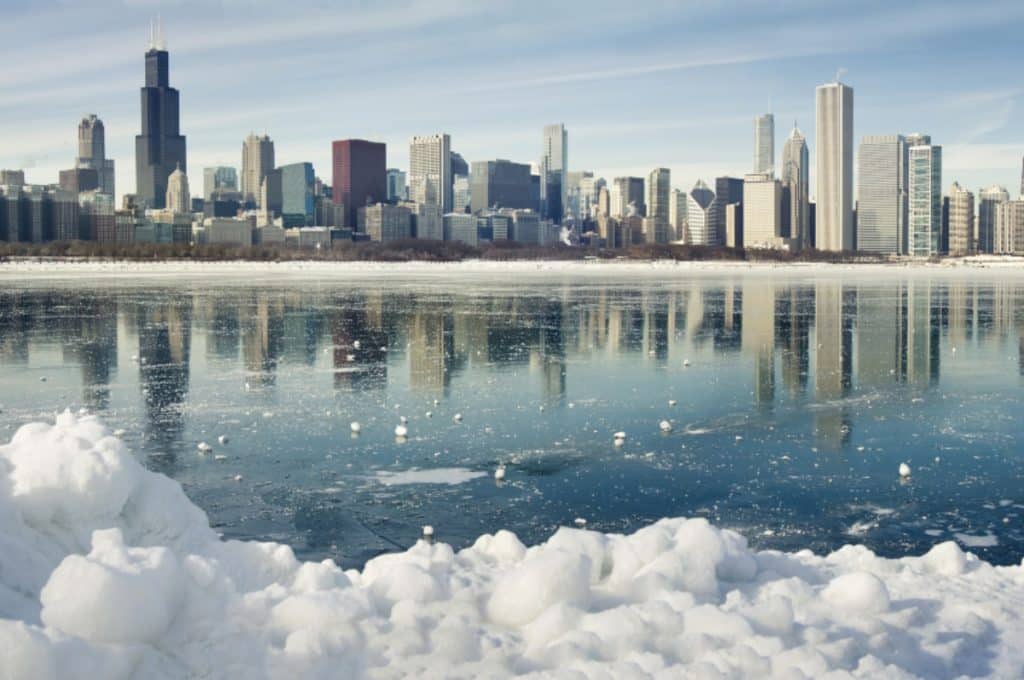 Chicago city buildings pictured across the lake with snow on the ground