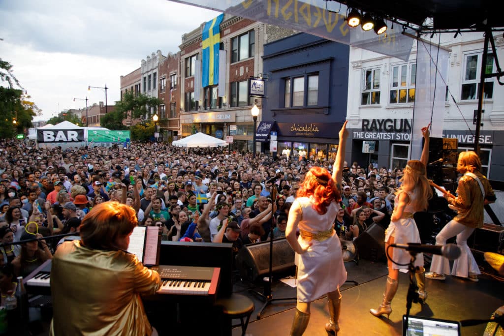 Image of an ABBA tribute act performing on stage during Chicago's Andersonville Midsommarfest