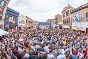 Image of crowds watching a live music performance at a stage at Andersonville Midsommarfest in Chicago