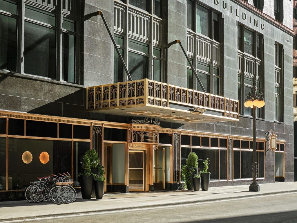 Exterior of The Pendry Chicago shows a grand overhand with the hotel name on it
