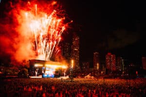 fireworks over lolla stage with thousands of people attending 