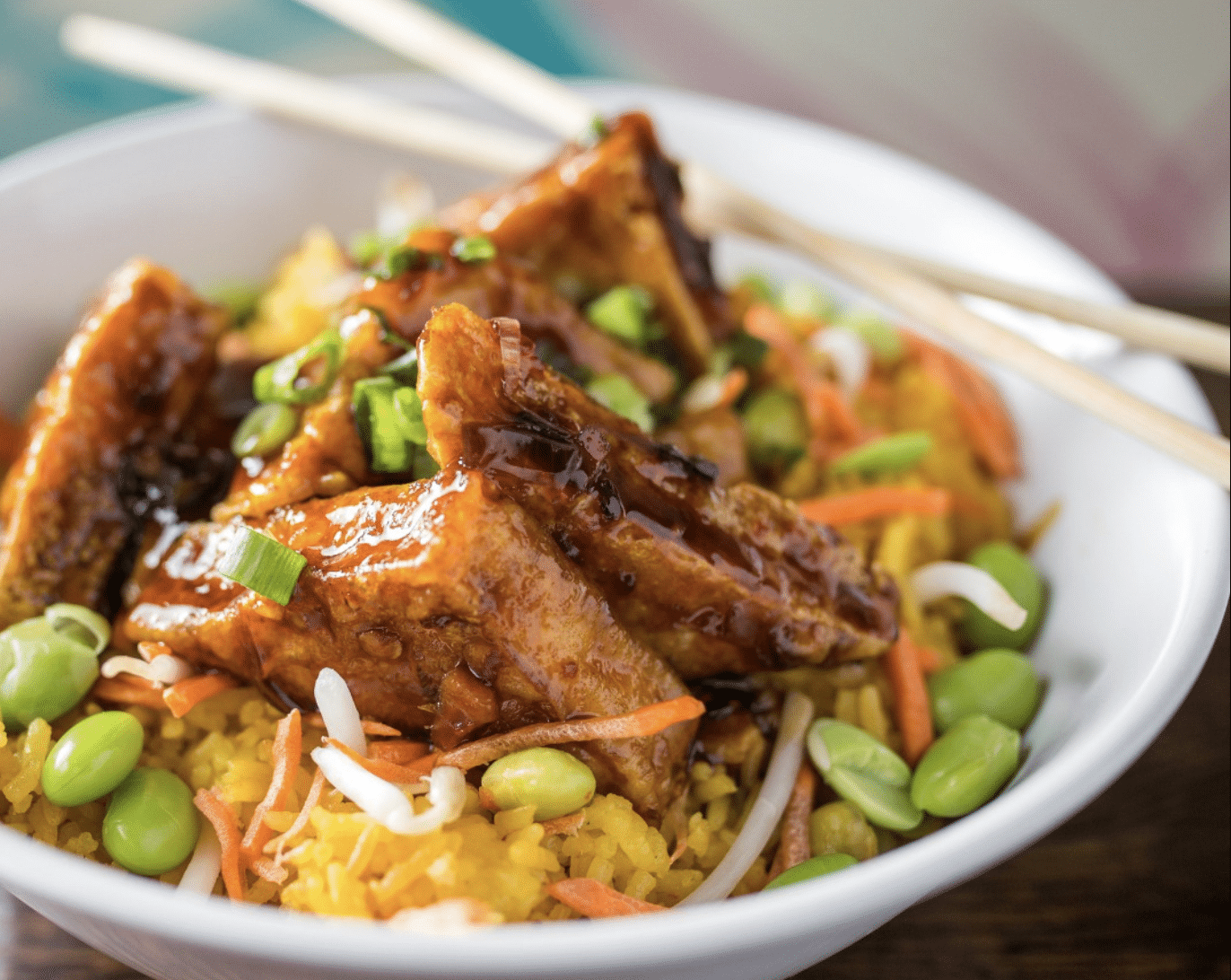 The Puerto Rican Rice Bowl in a white ceramic bowl with chopsticks from Saucy Pork in chicago