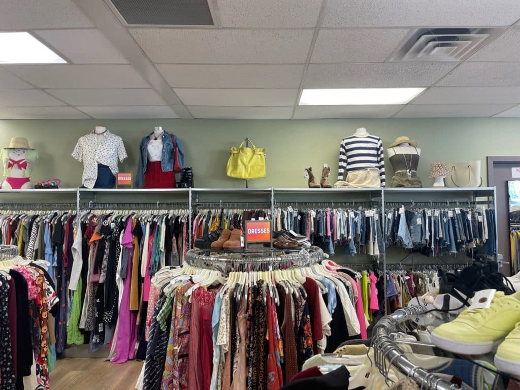 interior with racks of clothing at mannequins on the shelves at Buffalo Exchange