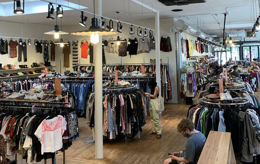 racks of shirts, pants, dresses in different sizes at crossroads trading company