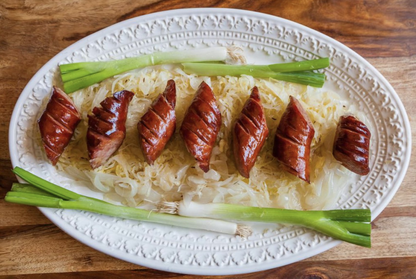 Polish sausage & sauerkraut with green onion at red apple buffet in chicago