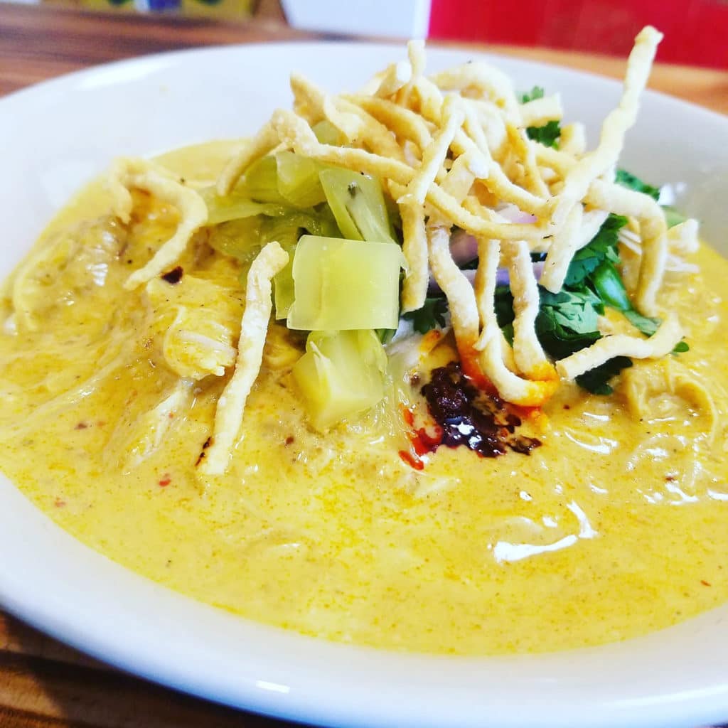Wheat noodles, khao soi curry coconut broth, chicken, pickled mustard greens, shallots, cilantro and topped with crispy noodles from Ghin Khao Eat Rice in Chicago