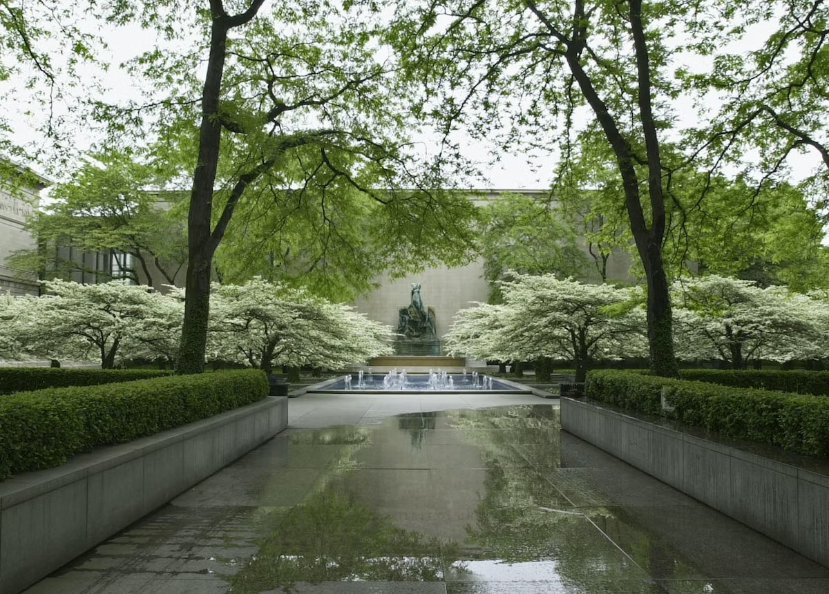 South Garden at the Art Institute of Chicago with fountain placed against the Morton Building and framed by the flowering hawthorns and graceful locusts. 