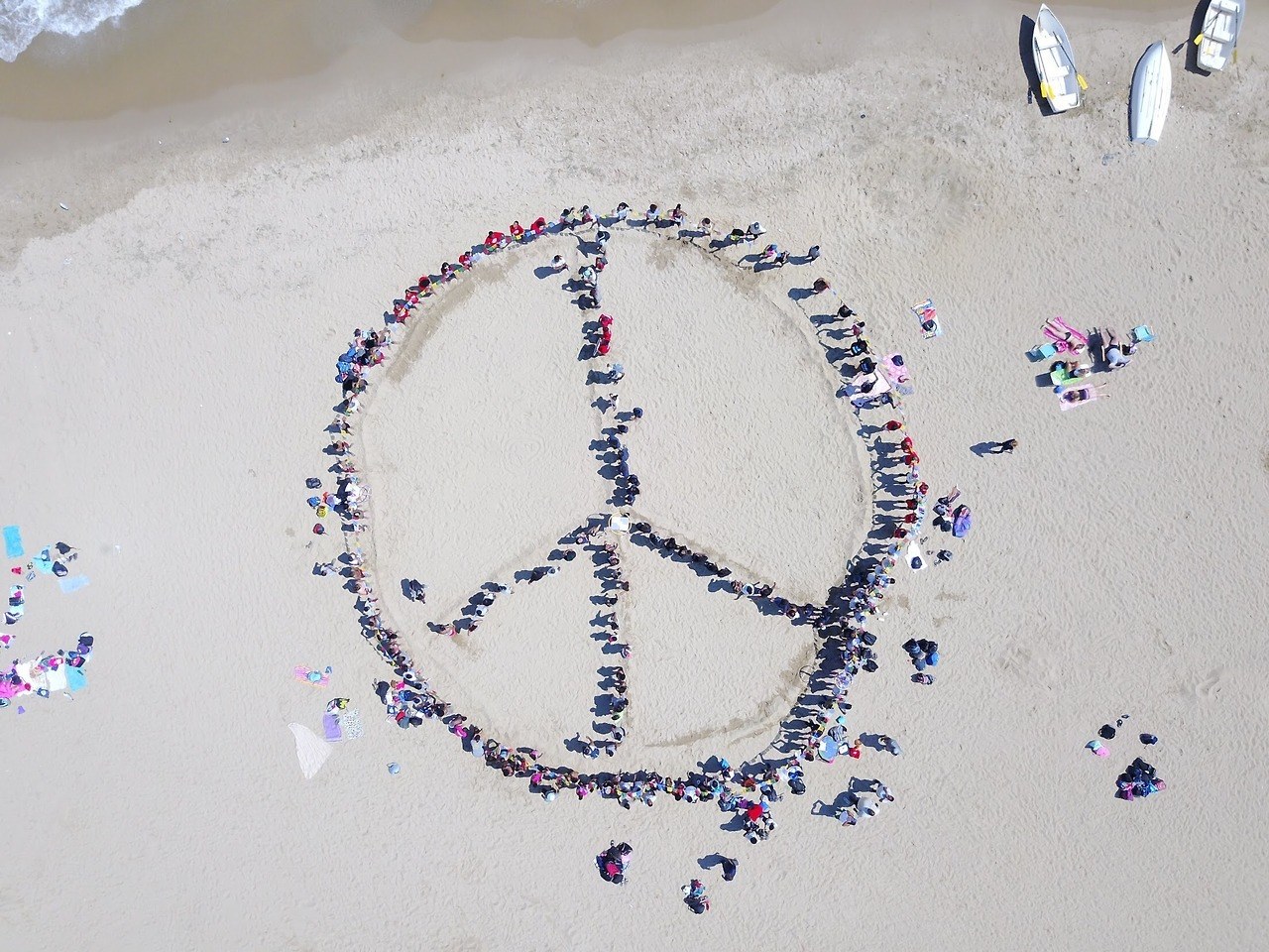 peace sign in the sand made of people on Margaret T. Burroughs beach